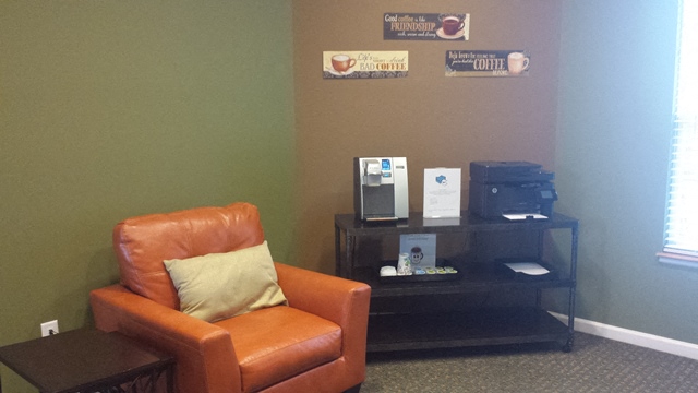 a living room with a leather chair and a table